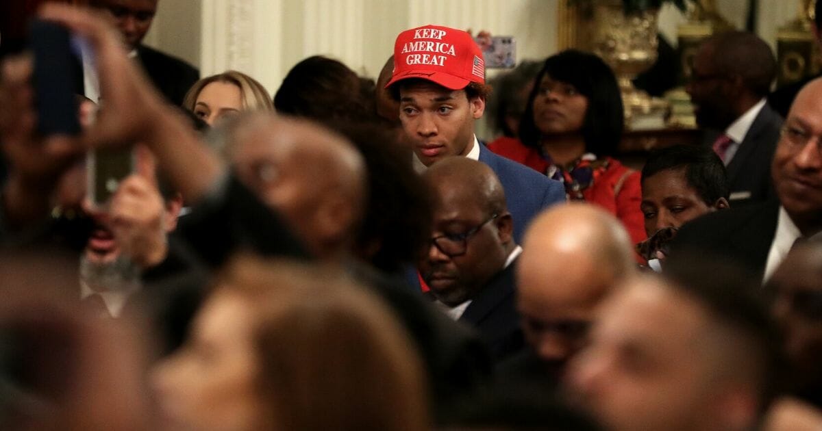 Guests listen to U.S. President Donald Trump during a Black History Month reception