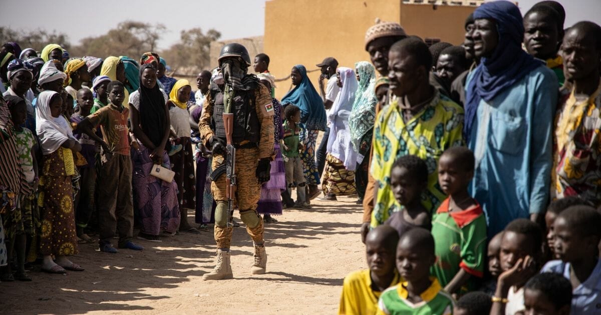 A Burkina Faso soldier patrols at district welcoming internally displaced people from northern Burkina Faso in Dori, on Feb. 3, 2020.