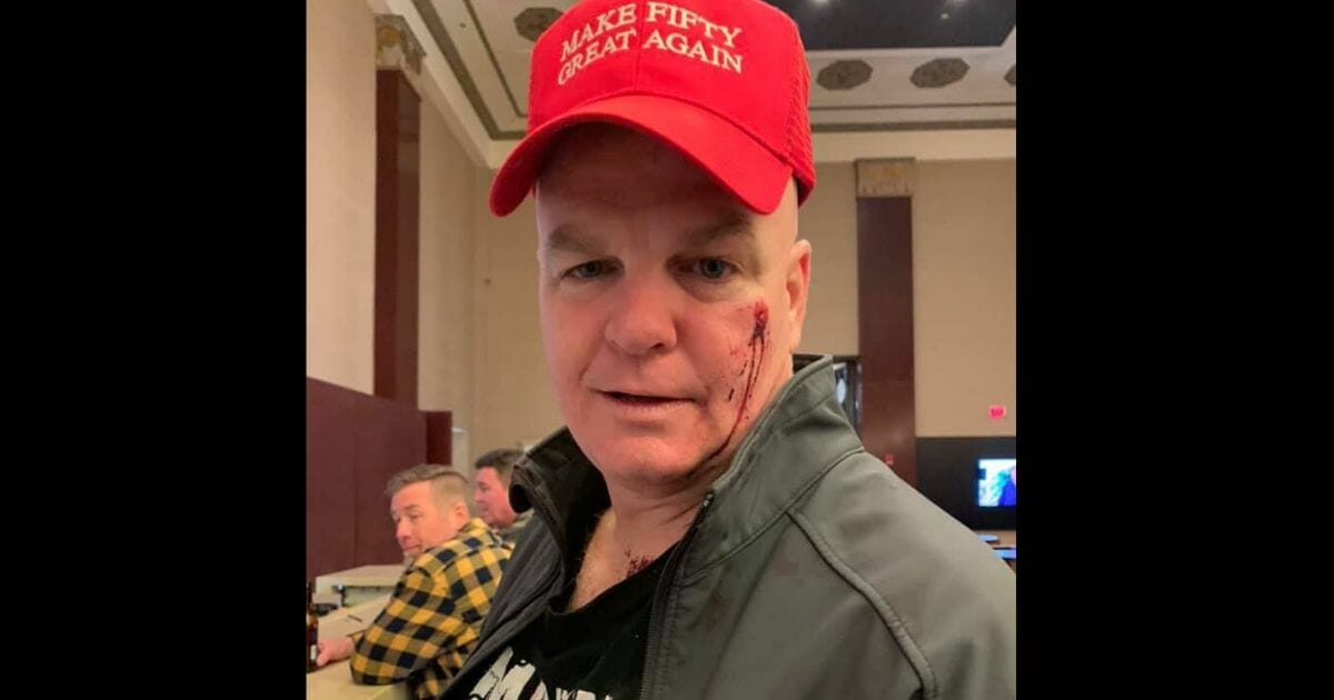 A New York man visiting Nashville for his 50th birthday was allegedly punched in the face at a downtown bar for wearing a hat emblazoned with a play on words of President Donald Trump's 2016 campaign slogan.