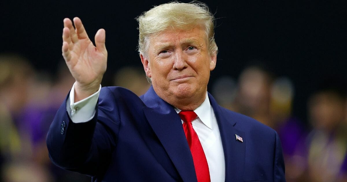 President Donald Trump waves prior to the College Football Playoff National Championship game between the Clemson Tigers and the LSU Tigers at Mercedes Benz Superdome on Jan. 13, 2020, in New Orleans, Louisiana.