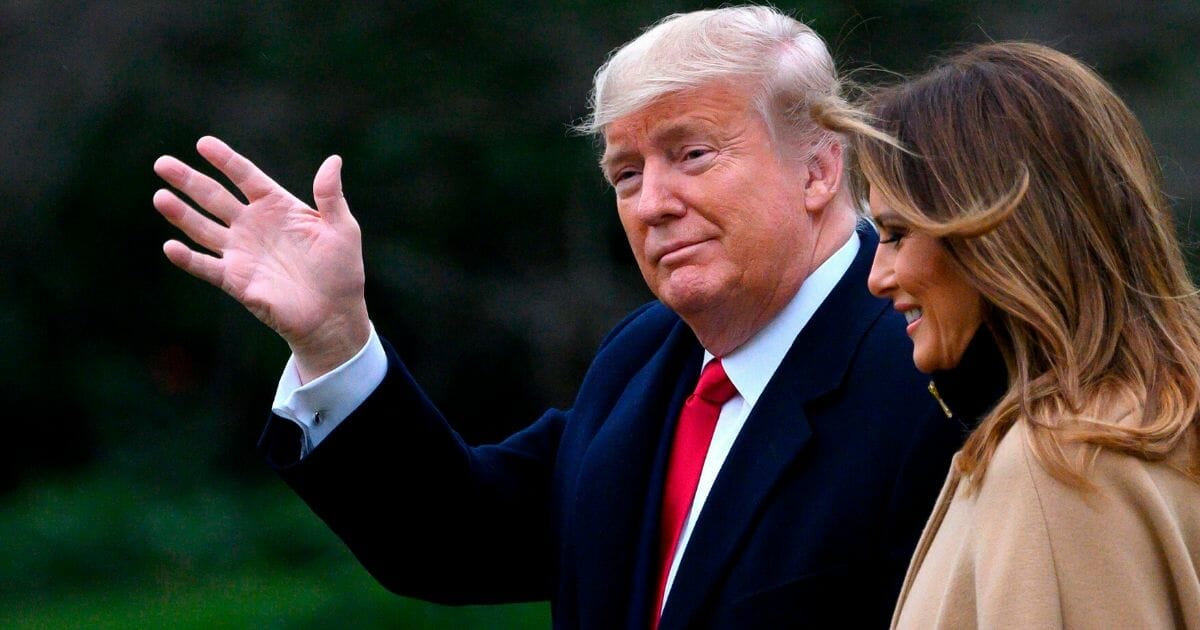 President Donald Trump waves as he and first lady Melania Trump walk to Marine One before departing from the South Lawn of the White House on Jan. 31, 2020.