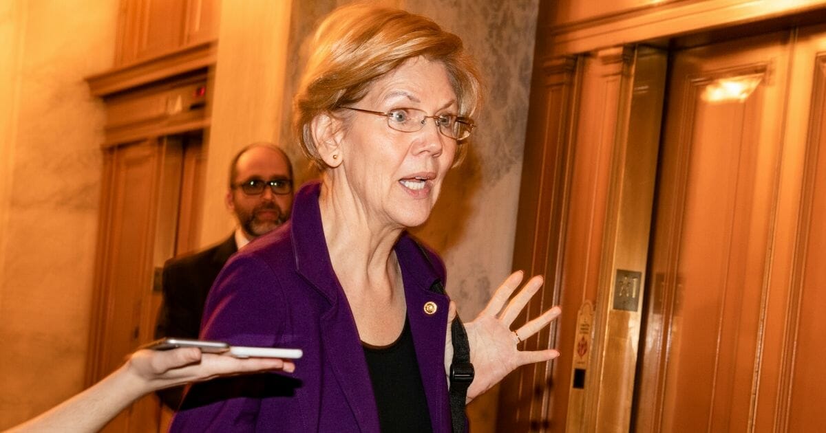 Sen. Elizabeth Warren (D-Massachusetts) responds to shouted questions as she heads to Iowa on Feb. 3, 2020, in Washington, D.C.