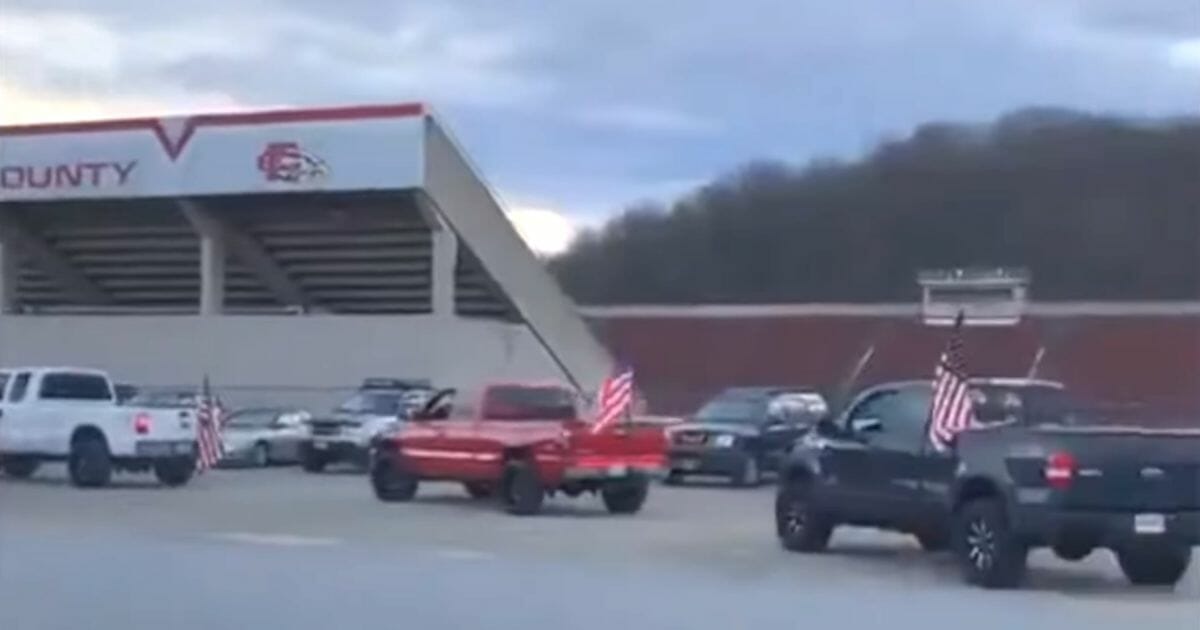 Trucks flying American flags arrive at Franklin County High School in Virginia.