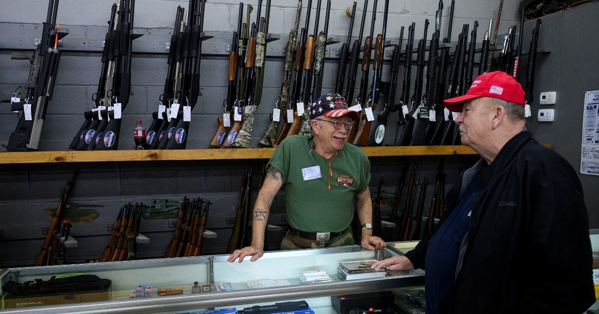 An employee speaks with a customer inside the Knob Creek gun shop in Bullitt County, Kentucky, on April 12, 2019.
