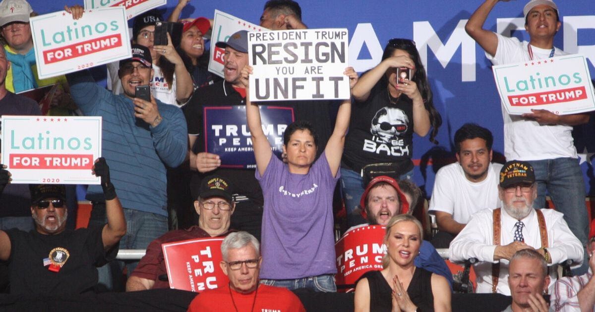 A protester holds a sign at President Donald Trump's rally in Phoenix on Feb. 19, 2020.