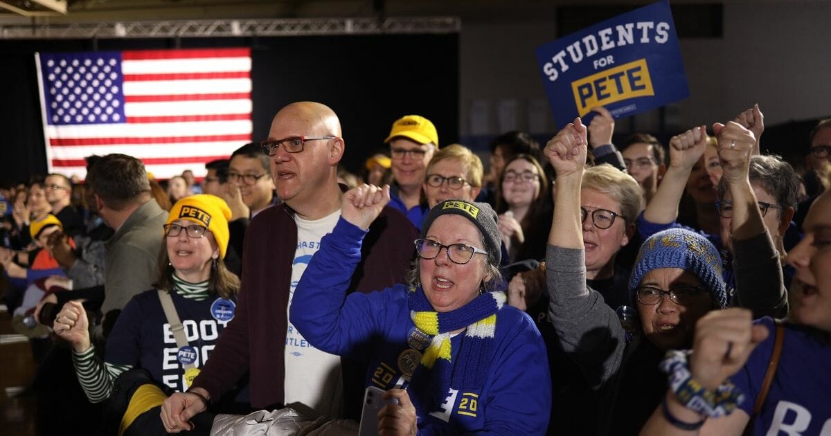 Supporters of Democratic presidential candidate former South Bend, Indiana, Mayor Pete Buttigieg watch early caucus results at a watch party at Drake University on Feb. 3, 2020, in Des Moines, Iowa.