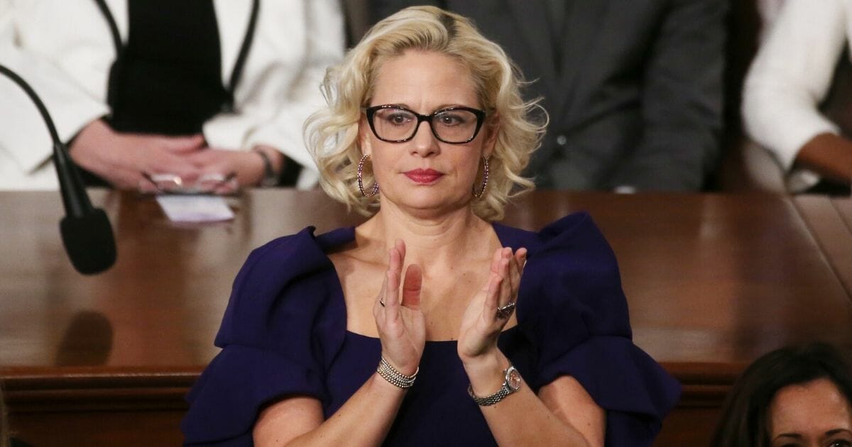 Sen. Krysten Sinema (D-Arizona) applauds during the State of the Union address in the chamber of the House of Representatives on Feb. 4, 2020, in Washington, D.C.