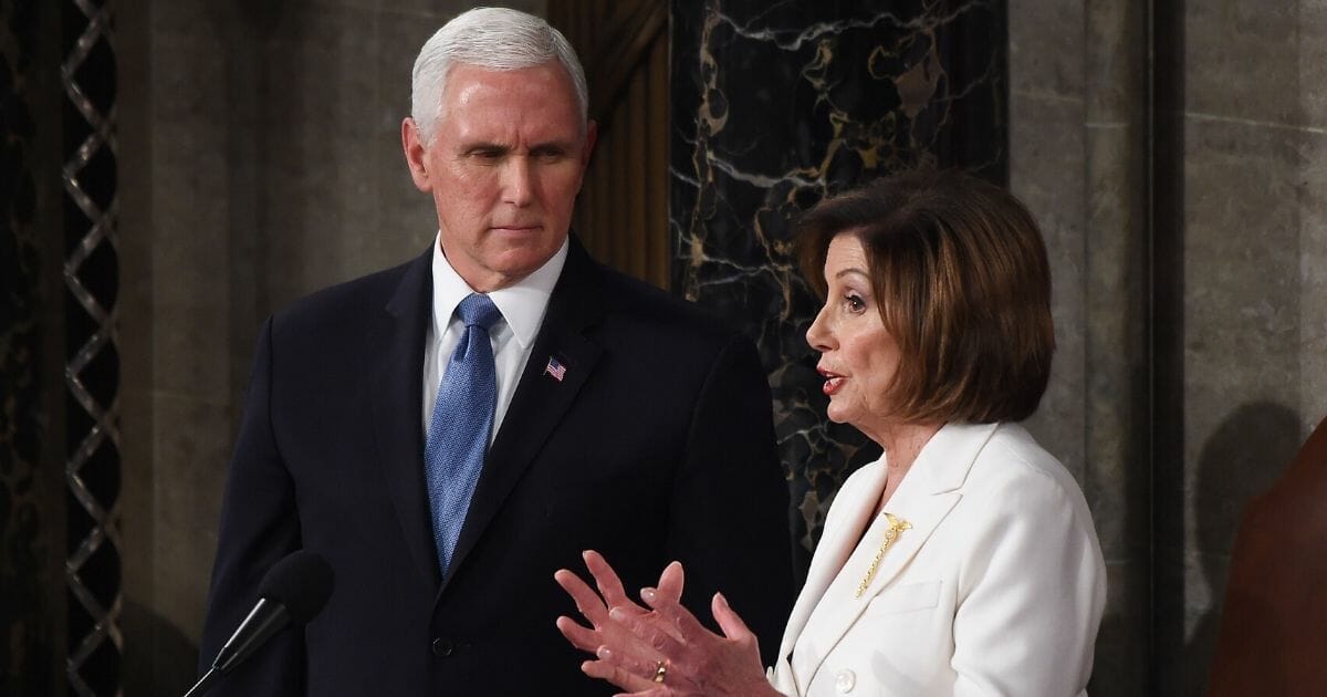 Vice President Mike Pence listens to House Speaker Nancy Pelosi before President Donald Trump's State of the Union address at the U.S. Capitol in Washington on Feb. 4, 2020