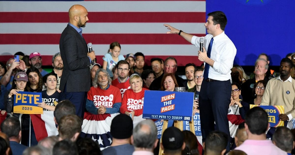 Democratic presidential candidate former South Bend, Indiana, Mayor Pete Buttigieg, right, answers an audience question read by actor Keegan-Michael Key during a rally at Rancho High School on Feb. 16, 2020, in Las Vegas, Nevada.