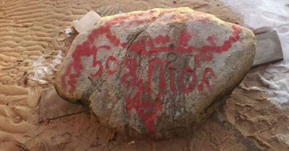Plymouth Rock was defaced with red paint and graffiti.