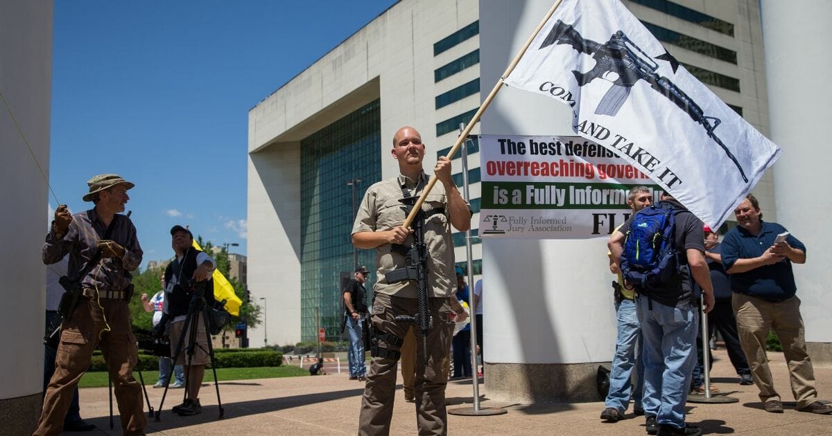 James Singer, center, and others stand up for the Second Amendment in response to protesters opposing the NRA's convention In Dallas on May 5, 2018.