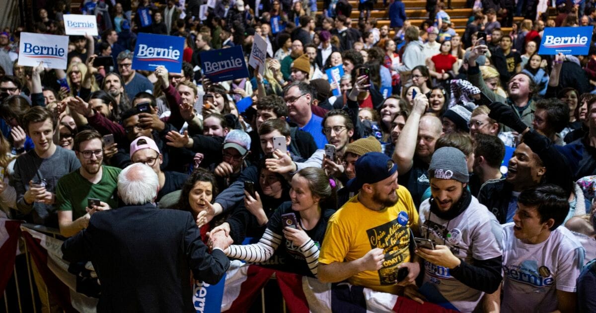 Democratic presidential candidate Sen. Bernie Sanders of Vermont shakes hands with supporters as he wraps up a rally at the Arthur Ashe Junior Athletic Center in Richmond, Virginia, on Feb. 27, 2020.