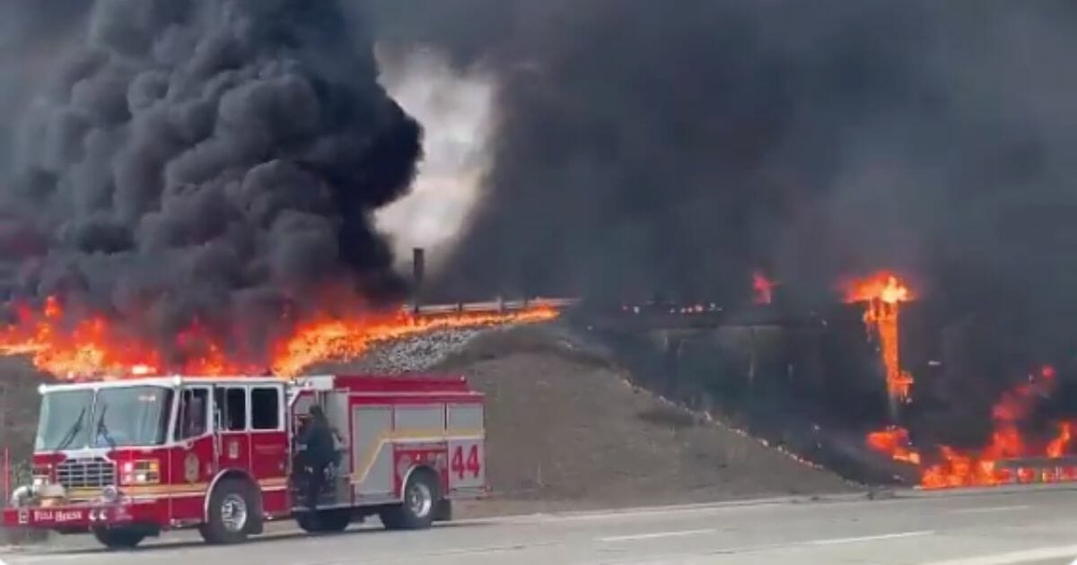 A truck driver is alive and in critical condition after being rescued from his overturned oil tanker that exploded on an Indianapolis freeway Thursday afternoon.