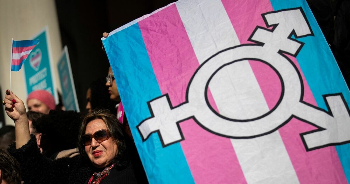 LGBT activists and their supporters rally in support of transgender people on the steps of New York City Hall on Oct. 24, 2018, in New York City.