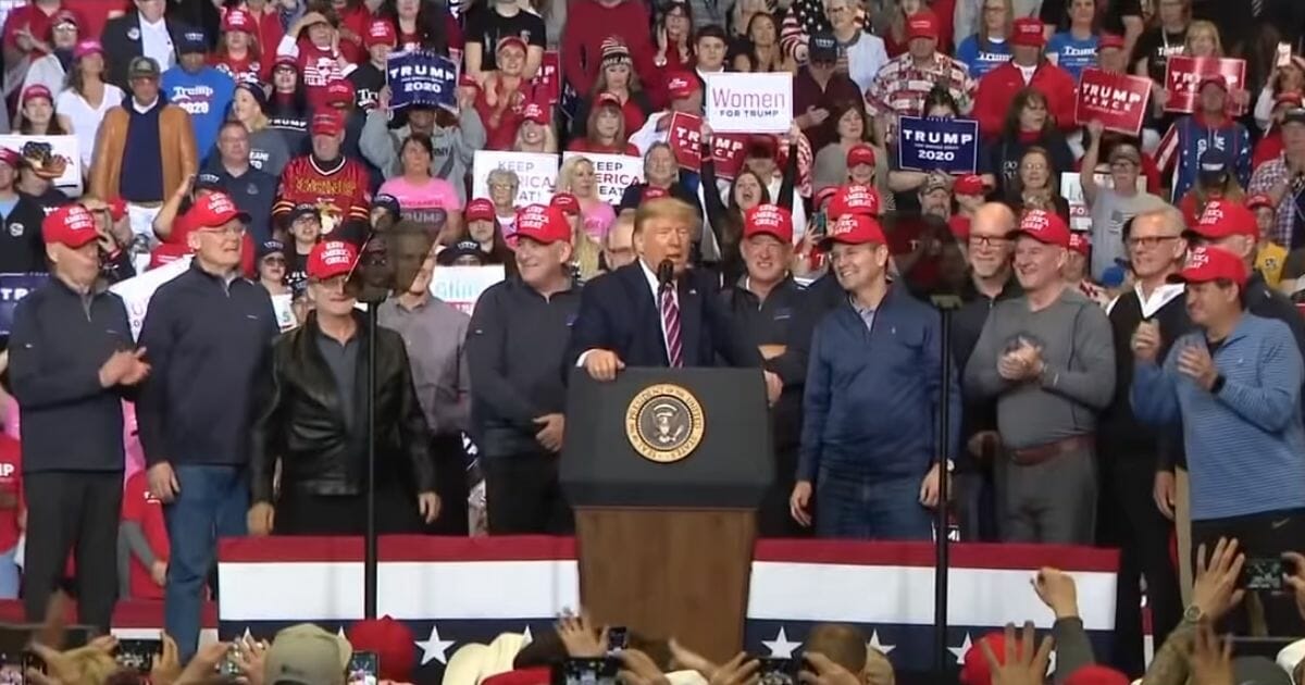 Members of the 1980 "Miracle on Ice" U.S. hockey team appear on stage with President Donald Trump at a rally in Las Vegas.