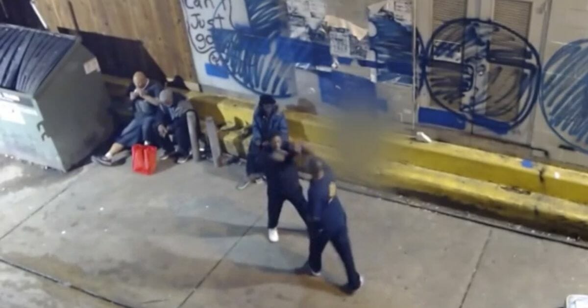 Men fighting in an Austin, Texas alley.