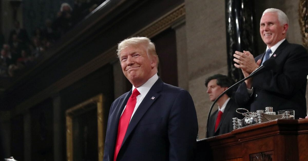 President Donald Trump arrives as Vice President Mike Pence looks on before the State of the Union address in the House chamber on Feb. 4, 2020, in Washington, D.C.