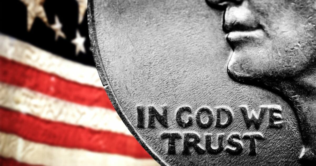 Stock image of a coin bearing the U.S. national motto, "In God We Trust."