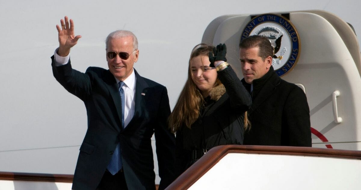 Then-Vice President Joe Biden arrives in Beijing in December 2013 with his granddaughter, Finnegan Biden, and son Hunter Biden.