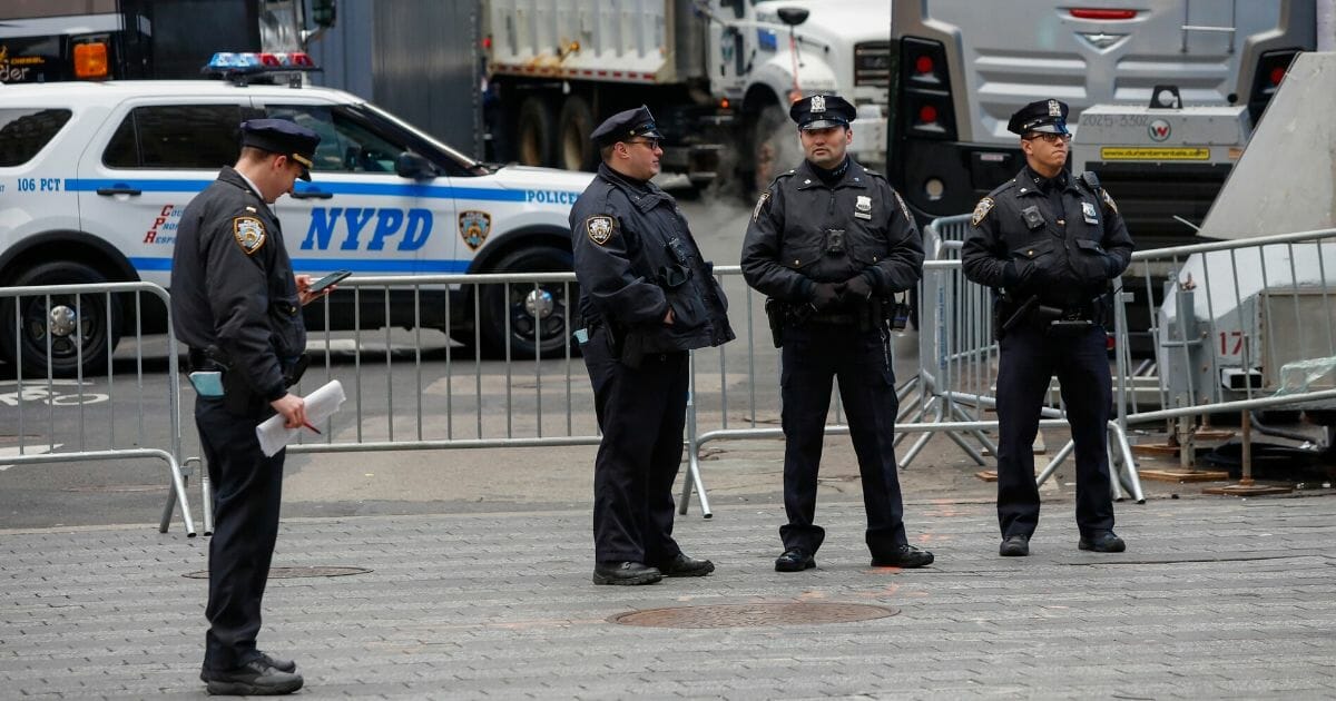 New York City police officers stand guard before the city's iconic New Year's celebration in Times Square on Dec. 31. On Saturday and Sunday, police officers were wounded in armed attacks police say were carried out by the same man.