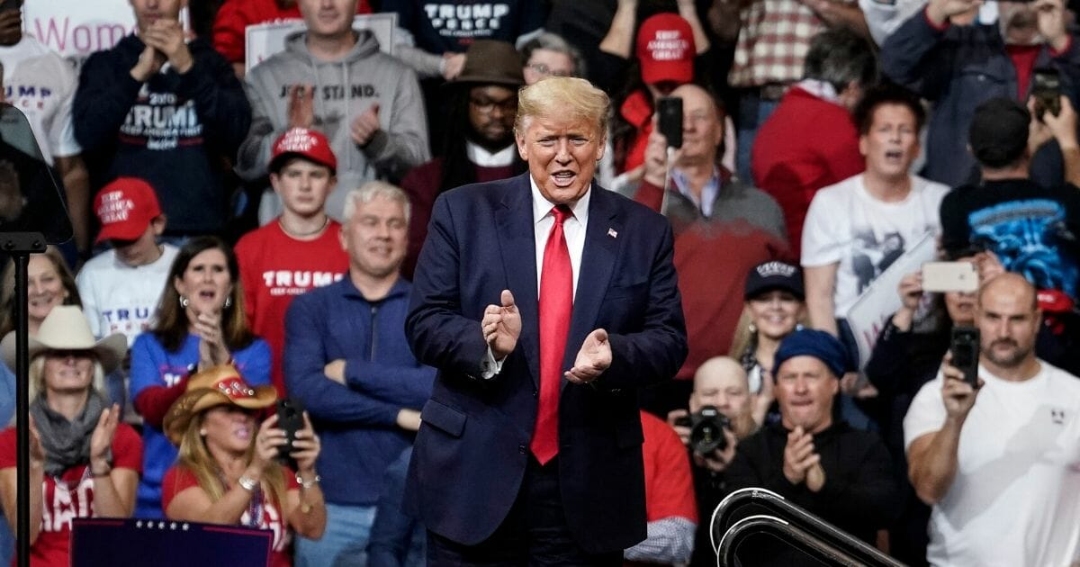 President Donald Trump applauds his audience Monday during a "Keep America Great" re-election rally in Manchester, New Hampshire.