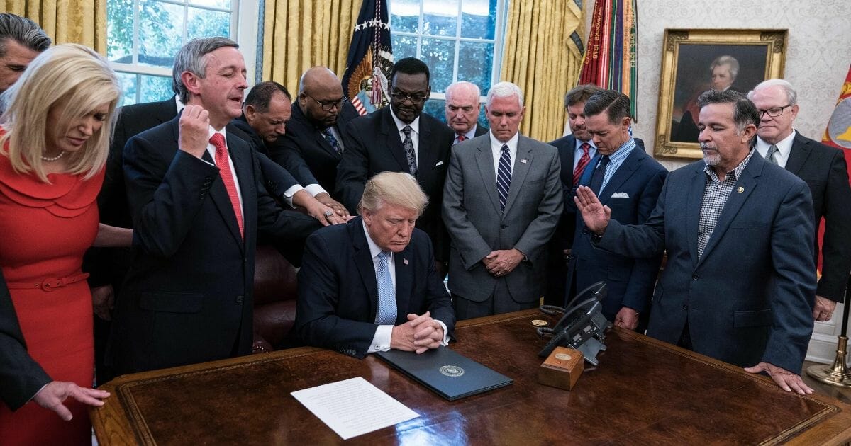 President Donald Trump and faith leaders pray in the Oval Office at the White House after Trump signed a proclamation calling for a national day of prayer on Sept. 3 for those affected by Hurricane Harvey in Washington, D.C.