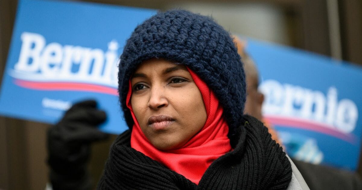 Democratic Rep. Ilhan Omar of Minnesota listens during a rally for Democratic presidential candidate Sen. Bernie Sanders of Vermont outside the Hennepin County Government Center on the first day of early voting on Jan. 17, 2020, in Minneapolis.
