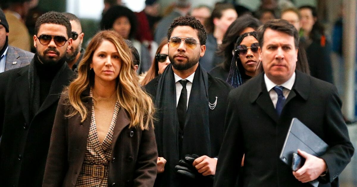 Flanked by attorneys and supporters, actor Jussie Smollett, third from left, arrives at the Leighton Criminal Courthouse on Feb. 24, 2020, in Chicago.