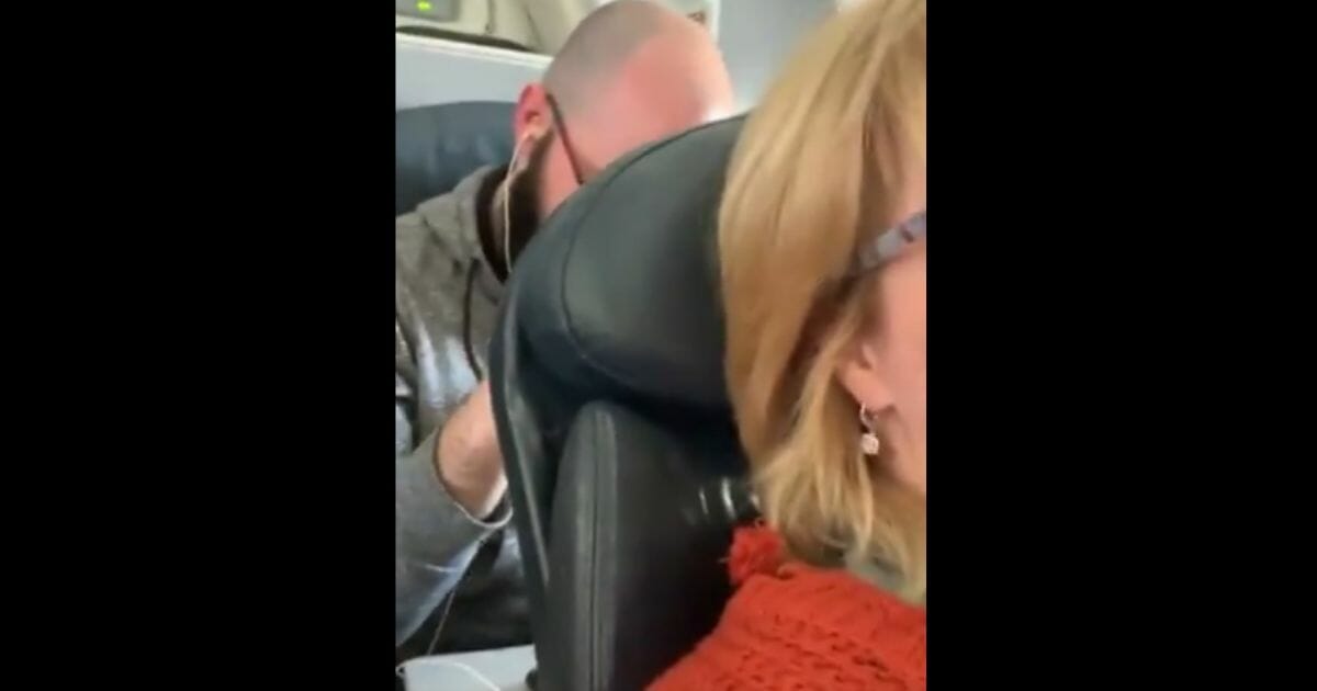 One woman's video of the airline passenger behind her punching the back of her reclined seat went viral last week. Now she is looking to sue American Airlines.