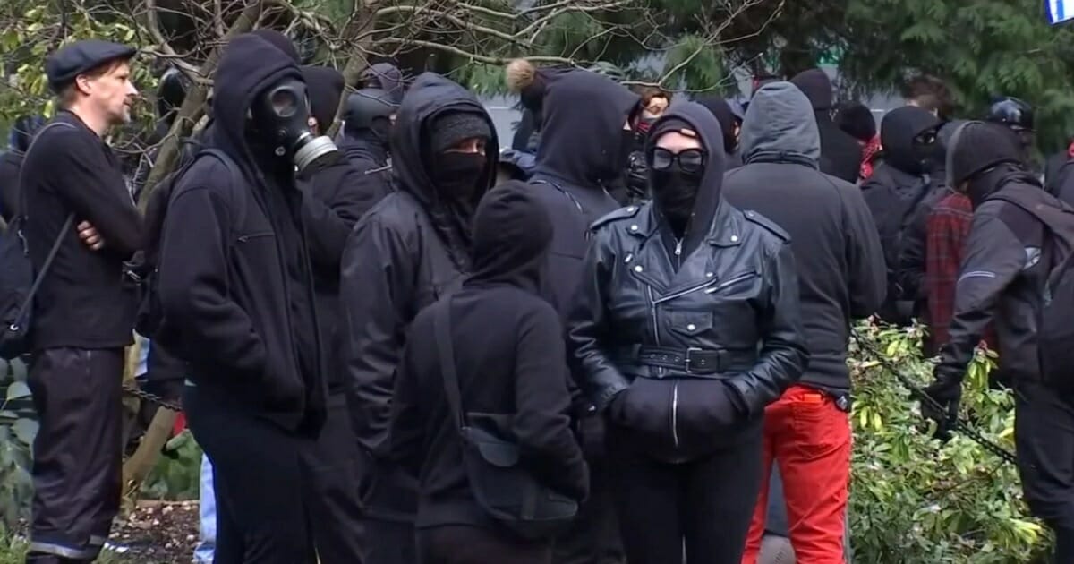 Masked antifa demonstrators gather Saturday in Portland, Oregon.