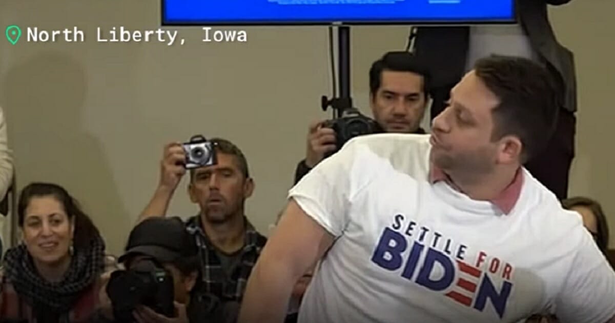 Man wearing a "Settle for Biden" T-shirt interrupts a campaign event featuring Vice President Joe Biden in Iowa on Saturday..