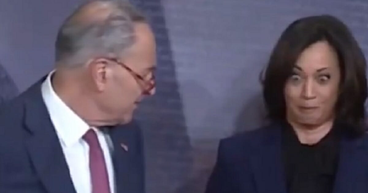 Senate Minority Leader Chuck Schumer appears to cold Sen. Kamala Harris on Friday as Harris makes a face.