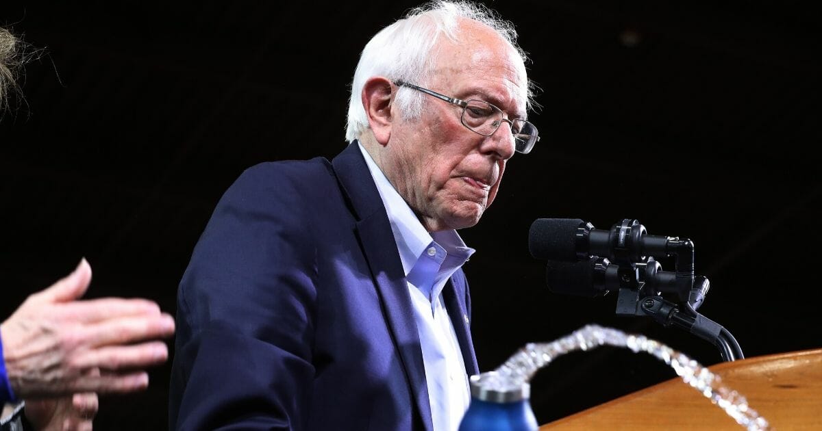 Democratic presidential candidate Sen. Bernie Sanders (I-Vermont) accidentally spills his bottle of water while addressing a rally with at the Champlain Valley Expo on March 3, 2020, in Essex Junction, Vermont.