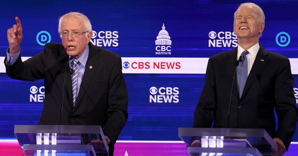 Vermont Sen. Bernie Sanders, left, speaks as former Vice President Joe Biden reacts during the Democratic presidential primary debate at the Gaillard Center in Charleston, South Carolina, on Feb. 25, 2020