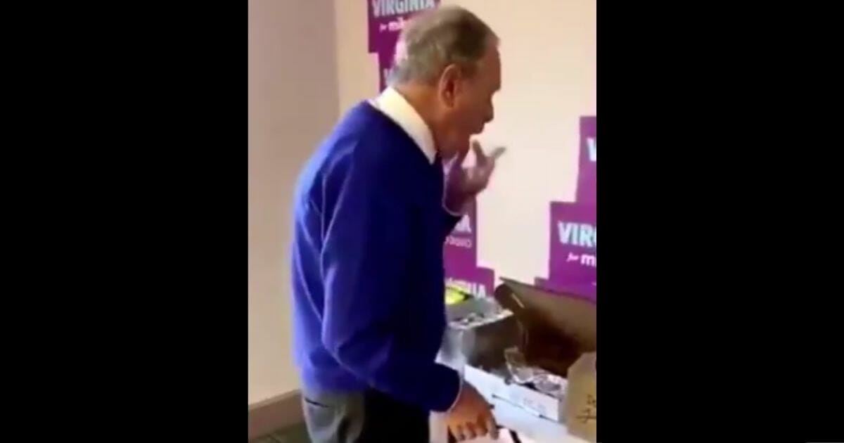 Mike Bloomberg licks his fingers.