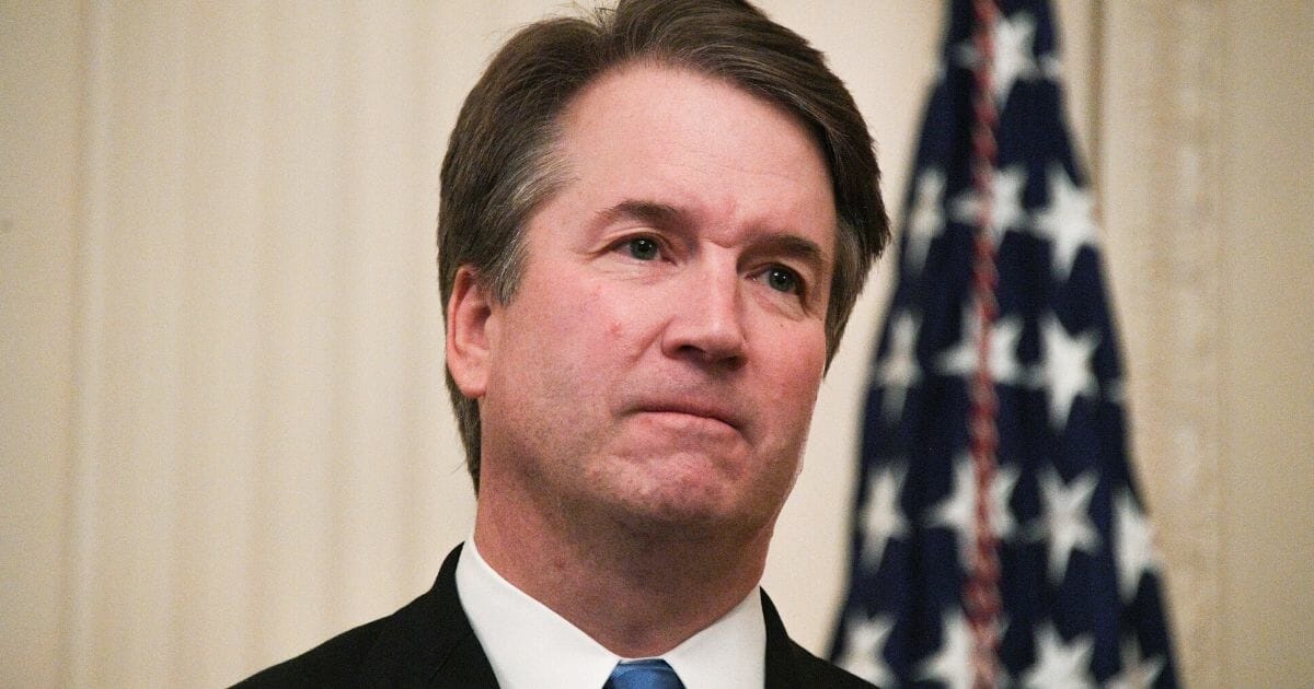 Brett Kavanaugh waits before being sworn in as a Supreme Court justice at the White House on Oct. 8, 2018.