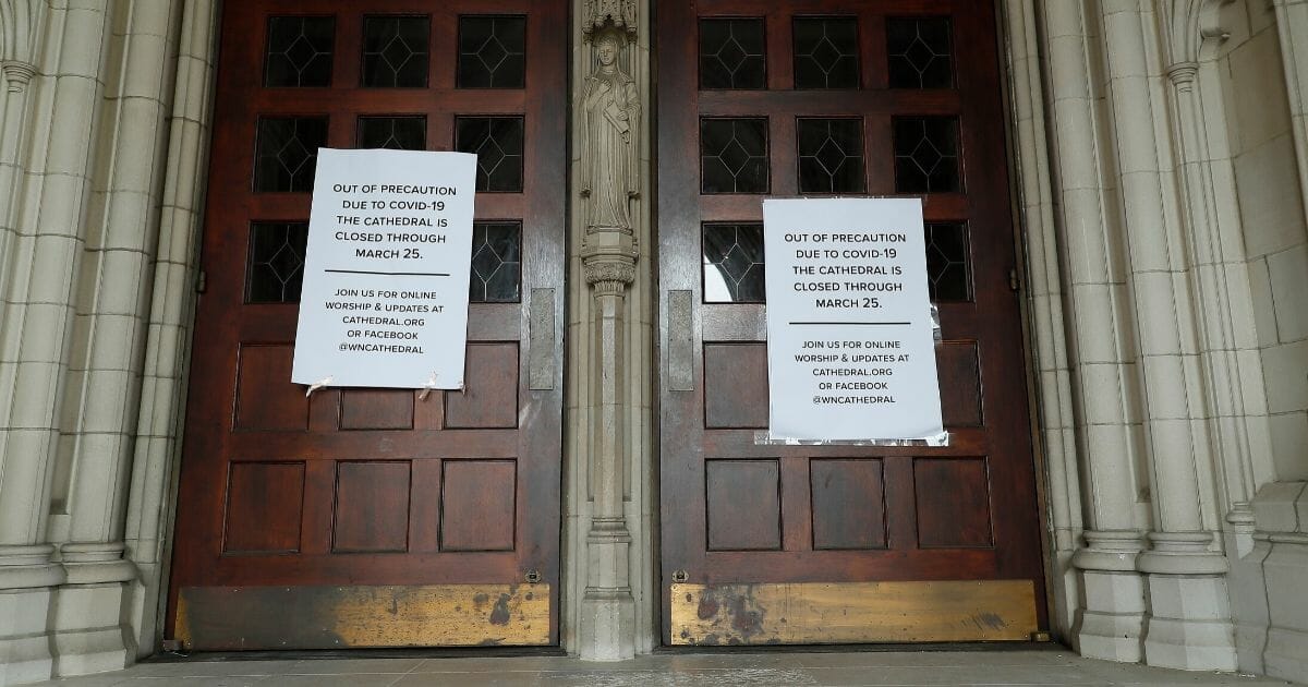 Signs give notice to visitors that the Washington National Cathedral in D.C. is closed to the public March 19, 2020, due to the coronavirus outbreak.