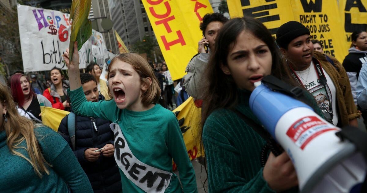 Children and teens march along Market Street in San Francisco during a youth climate strike on Dec. 6, 2019.