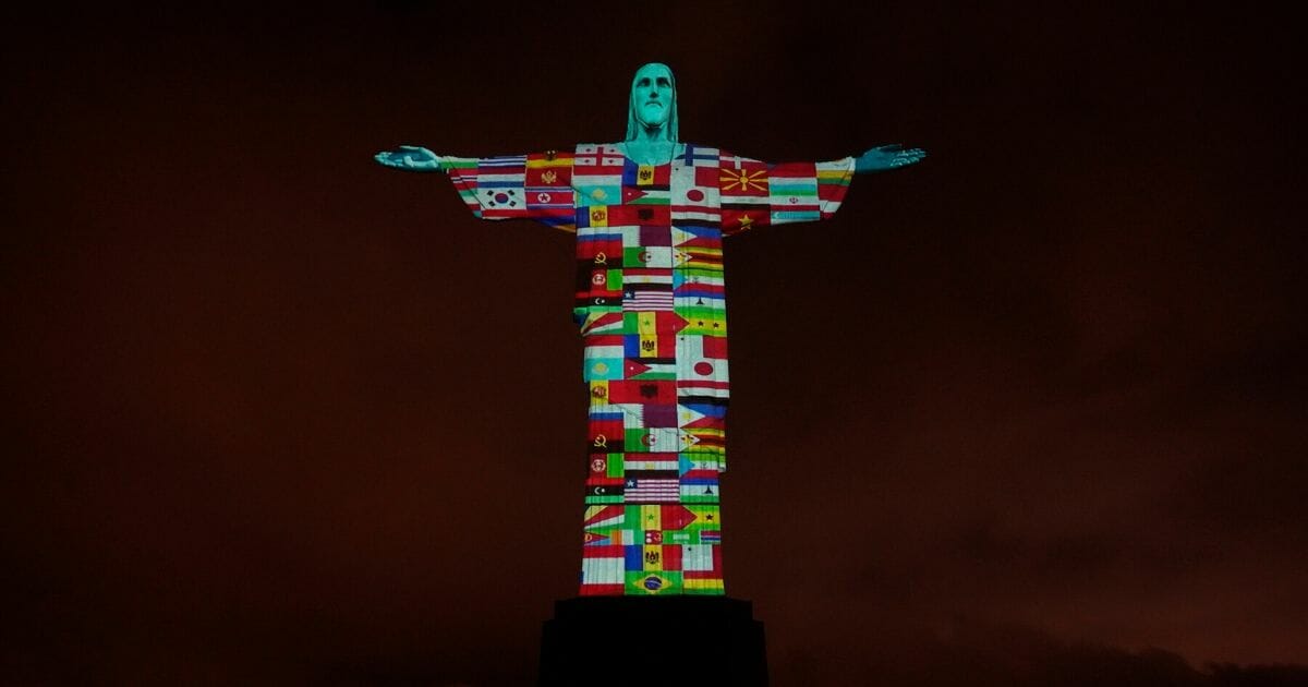 The illuminated statue of Christ the Redeemer statue is seen as Dom Orani Tempesta, archbishop of the city of Rio de Janeiro, performs a mass in honor of the victims of COVID-19 around the world on March 18, 2020, in Rio de Janeiro, Brazil.