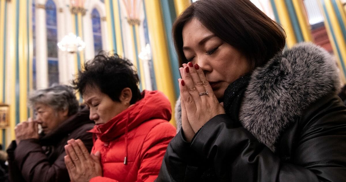 Worshipers attend a Christmas Eve mass at the Xishiku Cathedral in Beijing on Dec. 24, 2019.