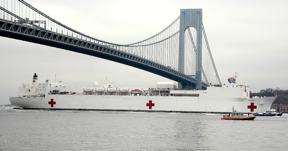 The USNS Comfort travels under the Verrazzano-Narrows Bridge on March 30, 2020, as it heads to New York City's Pier 90 to supply additional medical infrastructure amid the coronavirus pandemic.