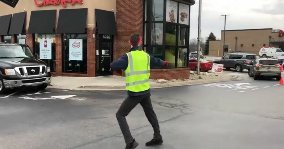 Chick-fil-A employee Dan Morgan dances in the drive-thru.