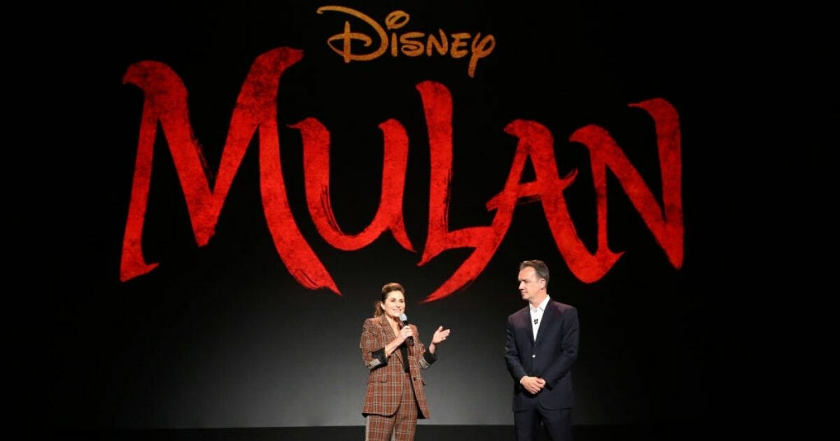 "Mulan" director Niki Caro, left, and President of Walt Disney Studios Motion Picture Production Sean Bailey speak on stage Aug 24, 2019.