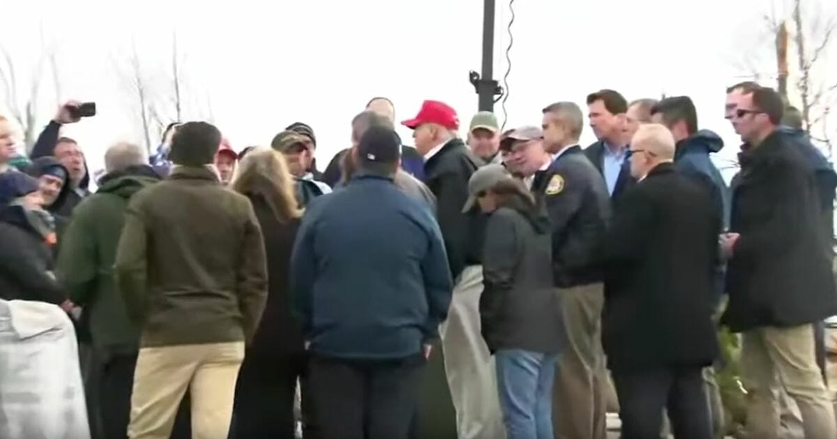 President Donald Trump was greeted with shouts of "Amen" on Friday after he spoke privately with victims of a tornado that slammed through Cookeville, Tennessee.