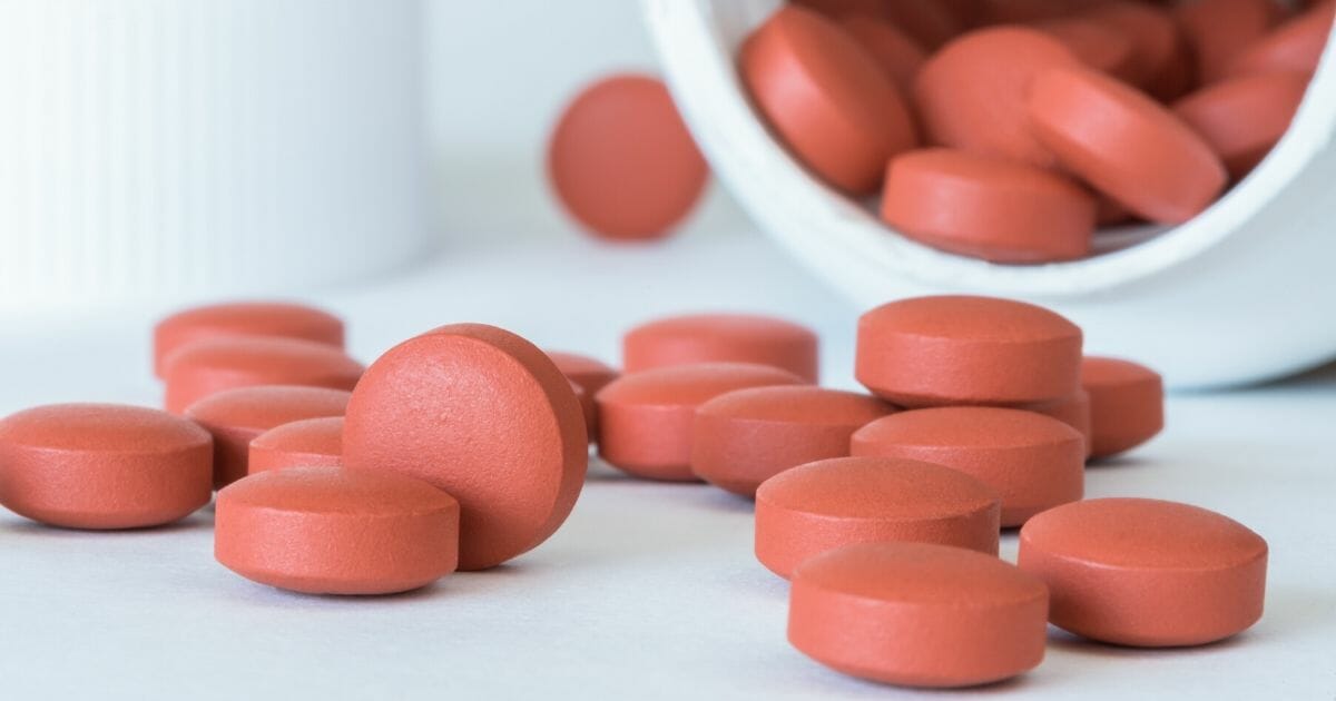 Tablets spilled from a bottle of ibuprofen.