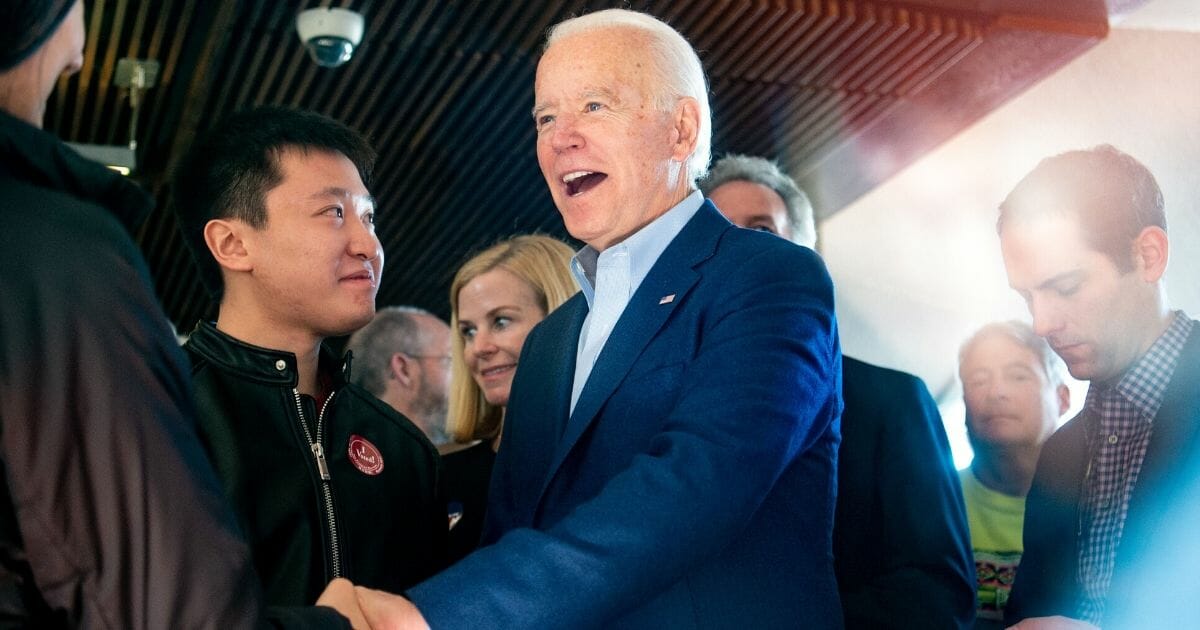 Democratic presidential candidate Joe Biden greets restaurant patrons at the Buttercup Diner in Oakland, California, on March 3, 2020.