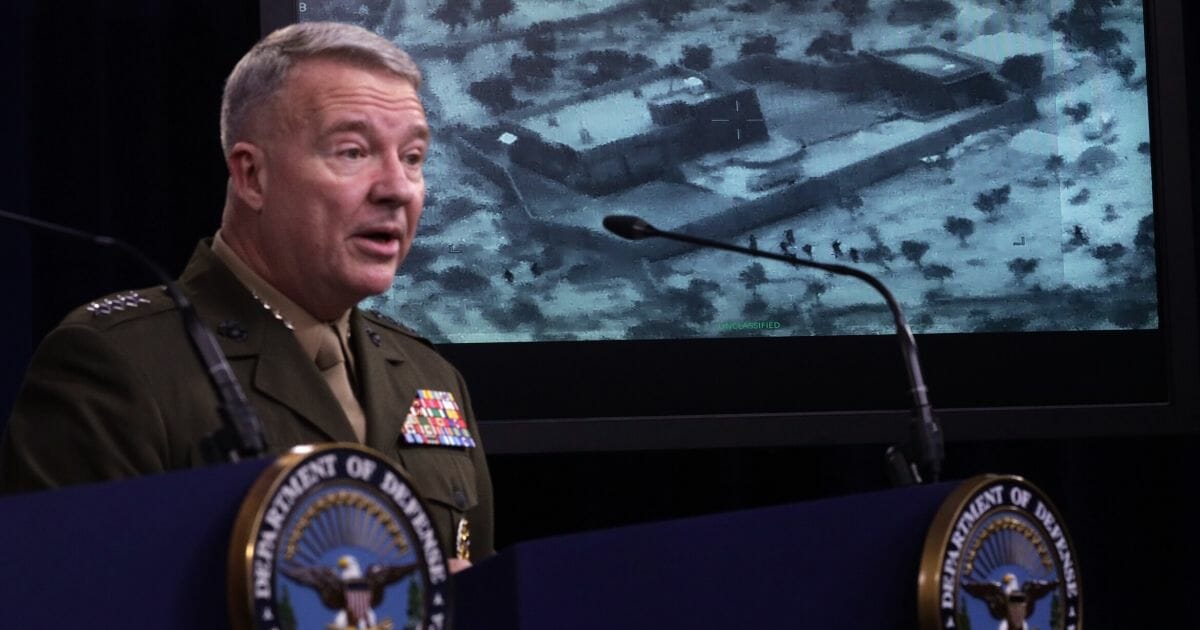 Marine Corps Gen. Kenneth McKenzie, commander of U.S. Central Command, speaks as a picture of the operation targeting Abu Bakr al-Baghdadi is seen during a news briefing Oct. 30, 2019, at the Pentagon in Arlington, Virginia.