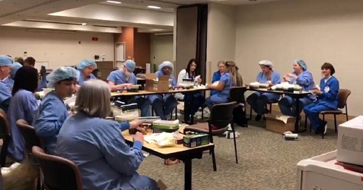 Operating room staffers at Baptist Memorial Hospital in Memphis, Tennessee, make up care packages while singing "Lean on Me."