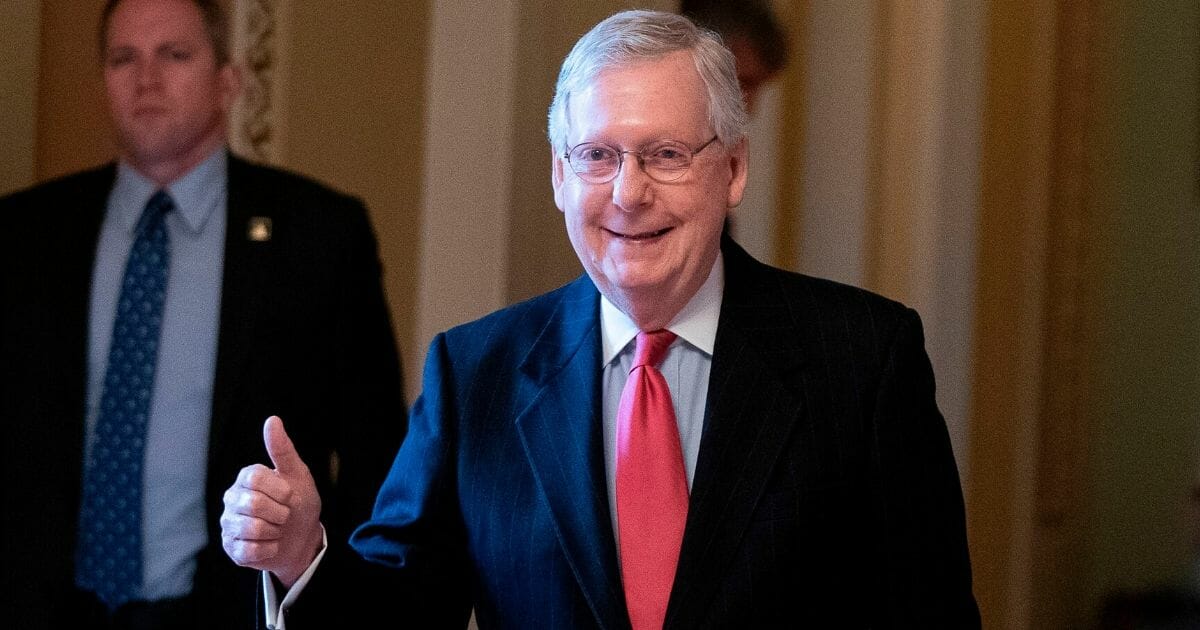 Senate Majority Leader Mitch McConnell gives a thumbs up as he leaves the Senate floor at the Capitol on March 25, 2020.