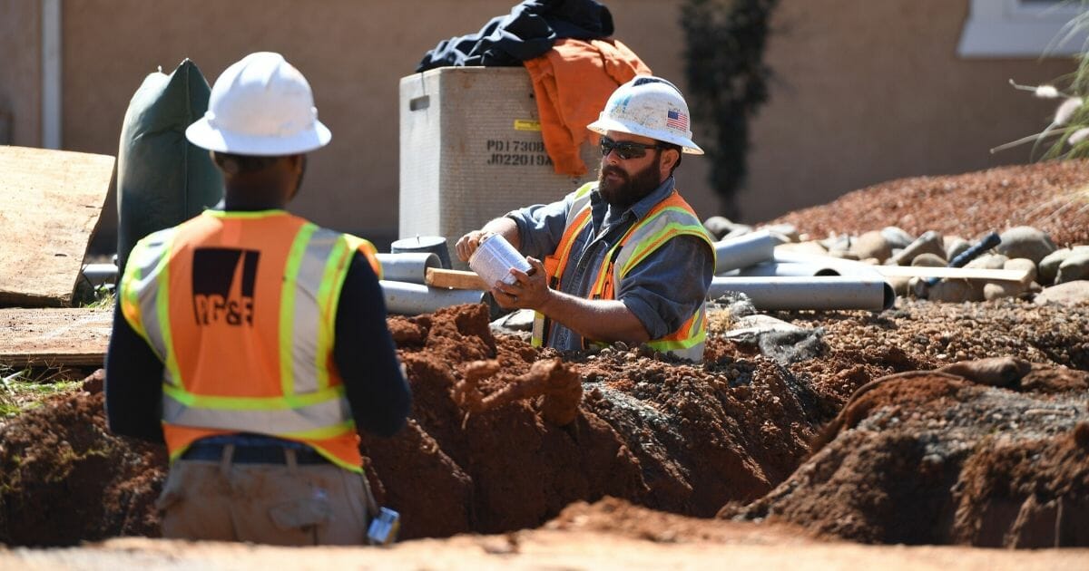 Pacific Gas & Electric Co. workers install a conduit for underground electric lines in Paradise, California, on Oct. 1, 2019.